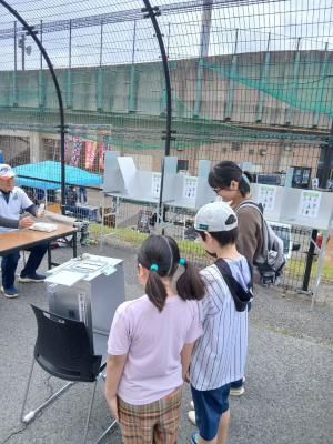 投票箱に何も入っていないことを確認している写真